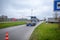 A wing of a wind turbine lies on a trailer on the highway