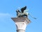 Winged lion above a column