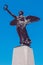 Winged victory statue. Monument to the war dead of the first world war. Winged angel with laurel in hand. Cloudless blue sky in