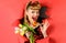 Winking woman with tulips shows sign ok. Smiling Pinup girl looking through paper. Happy female with Bouquet of flowers.