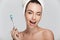 winking young woman with tooth brush