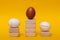 Winner, champion in the form of a standing golden egg and losers prize-winners pale and bursting laying eggs, abstract