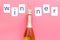 Winner congratulation concept with champagne on pink background top view