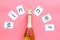 Winner congratulation concept with champagne on pink background top view