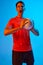 Winner emotions. Young male volleyball player with ball shouting isolated on blue studio background in neon light