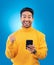 Winner, excited and portrait of Asian man with phone in studio for online bonus, competition and prize. Success