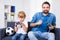 Winner and loser - father and son with gamepads playing video ga