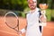 Winner in tennis holding beaker and racket