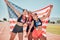 Winner, women and medal with American flag in celebration, goal or sports achievement on circuit. USA flag, runner group