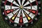 Winner yellow dart arrow hit center target of dartboard and other arrow loser metaphor marketing competition concept, on dark