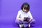 Winsome Caucasian Girl in White Shirt Posing With Gamepad Joystick And Wireless Headphones While Using Cellphone For Gaming Posing