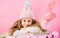 Winter accessory concept. Girl long hair dream pink background. Kid dreamy face wear knitted accessory. Winter fashion