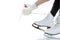 Winter Activity. Closeup of Teenager Girl Hands Lacing Up Ice Skates Against White