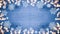 Winter / Advent / Christmas / holiday Background template - Frame made of ice crystals and sparkles bokeh lights on blue wooden