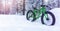 winter adventures - fat bike standing in the snow on snowy finland lapland forest background