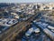Winter aerial of modern city with tall buildings, road moving cars along streets