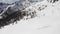 Winter aerial over group of people with snowshoes hiking down a snowy slope. Winter wonderland panorama with active