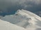 Winter alpine landscape, huge amount of blown snow, danger of snow avalanche