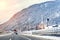 Winter alpine mountain highway and parallel railway road with intercity fast train and cloude sunset sky on background at cold day