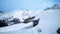 Winter alpine peaks, stone chalet buried in snow