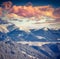 Winter alpine sunset in the mountains with dramatic sky