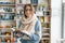 Winter autumn portrait of young beautiful girl student wearing glasses in knitted warm scarf and sweater reading book indoors