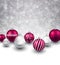 Winter background with magenta christmas balls.