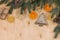 Winter background with spruce branches, dried oranges and a gift.