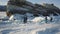 Winter Baikal Lake with tourists on ice having fun. Clip. Aerial view of people exploring wild nature of the frozen lake