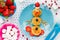 Winter breakfast idea for kids snowman from cheese pancake cheesecake with fruit and berry