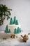 Winter cake. Christmas cake decorated with spruces on golden stand on gray background. Festive christmas, New Year table.