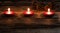 Winter candlelight with glowing small red candles and fir cones