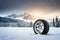 winter car tyre,sunset, mountains,and snow on dark trees Ai generated