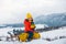 Winter child. Funny kid in snow sit on sled, sleigh. Child sledging outside in winter.