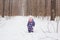 Winter, childhood and nature concept - baby girl walking in the winter outdoors