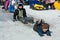 Winter children`s fun. The boy and the girl descend from the ice slide without devices. Sunny day