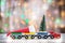 Winter Christmas background Miniature colorful train with fir tree. Holiday greeting card