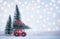 Winter Christmas background Miniature red car with fir tree. Holiday greeting card