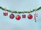 Winter Christmas creative concept of New Year decoration on drying clothes rope of evergreen tree with clothespin. Pastel blue