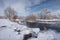 Winter Christmas Landscape In Blue Tones With Calm River, Surrounded By Trees. Landscape With Snowy Trees, Beautiful Frozen River
