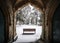 Winter churchyard grave yard with solitary bench in falling snow winter scene archway beautiful and peaceful blanket snowfall Nott