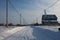 Winter cleared road travel among the snowdrifts in the winter in the Siberian village