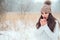 winter close up portrait of beautiful young woman in knitted hat and sweater walking outdoor