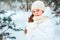 Winter close up portrait of cute dreamy child girl in white coat, hat and mittens