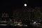 winter cloudless night view of the city - full moon over high-rise buildings