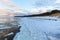 Winter coastal landscape with ice and snow on the beach