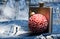 Winter cocktail drink concept. Metal flask for alcohol and christmas ball ornament on denim background. Celebrate new