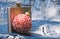 Winter cocktail drink concept. Metal flask for alcohol and christmas ball ornament on denim background. Celebrate new