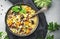 Winter comfort food. Warming high-calorie soup with pumpkin, mushrooms, potato, beef and barley. Gray table background, top view,