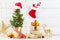 Winter composition with Christmas gift or present boxes, fir tree and golden holiday decorations on wooden background.